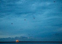 U.S. Sailors attached to Explosive Ordnance Disposal Mobile Unit (EODMU) 5 participate in a static line jump exercise in Apra Harbor, Guam, July 12, 2018.