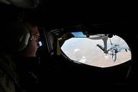 A U.S. Air Force KC-135 Stratotanker boom operator, assigned to the 340th Expeditionary Air Refueling Squadron, refuels a U.S. Navy F/A-18E Super Hornet over Iraq June 15, 2018.