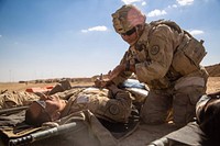 U.S. Army Sgt. Joshua Padilla, assigned to the 3rd Cavalry Regiment, writes vital information on a simulated casualty during a mass casualty exercise near the Iraqi-Syrian border, June 20, 2018.