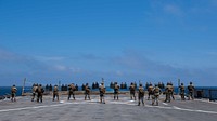 U.S. Marines assigned to the 26th Marine Expeditionary Unit (MEU), participate in a small arms gun shoot qualification on the flight deck of the Harpers Ferry-class dock landing ship USS Oak Hill (LSD 51) in the Atlantic Ocean July 13, 2018.