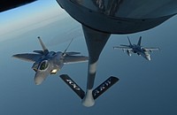 A U.S. Air Force F-22 Raptor and a Finnish air force F/A-18 Hornet fly behind a U.S. Air Force KC-135 Stratotanker during training off the coast of Finland, Oct 19, 2018.