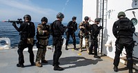 U.S. Sailors assigned to the Harpers Ferry-class amphibious dock landing ship USS Harpers Ferry (LSD 49) visit, board, search, and seizure team boards and prepare to search motor vessel MV ATLS-9701 during a VBSS training exercise in the Pacific Ocean, March 24, 2019.