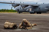 U.S. Army Private 1st Class Benjamin Alley, an infantryman serving with A Company, 5th Battallion, 20th Infantry Regiment, 1-2 Stryker Brigade Combat Team, 7th Infantry Division, stages in a security posture while more of his fellow Soldiers exit a C-130 Hercules on Palau International Airport, April 13, 2019.