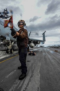 A U.S. Sailor assigned to Air Department simulates an aircraft fire during a mass casualty drill on the flight deck of the Navy’s forward-deployed aircraft carrier USS Ronald Reagan (CVN 76) in the Coral Sea, July 28, 2019.