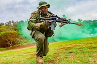 Lance Corporal Nabala Rua, assigned to 3rd Battalion, Fiji Infantry Regiment, rushes during a flanking maneuver demonstration at a cadet graduation in Napuka Village, Aug. 7, 2019.