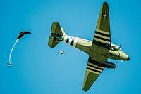 Two members of the Liberty Jump Team, a commemorative team of volunteer parachutists, jump out of a restored C-47 Skytrain over the skies of Fort Benning, Georgia, August 16, 2019.