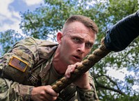 U.S. Army Sgt. Michael Yarrington, Army Reserve Drill Sergeant of the Year, navigates across a rope as part of an obstacle at Fort McCoy, Wisconsin, August 14, 2019.