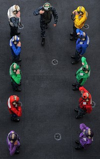 U.S. Navy Vice Adm. Richard W. Hunt, the commander of U.S. 3rd Fleet, salutes as he passes through an honor guard of flight deck crewmembers, known as rainbow sideboys, after arriving aboard USS Abraham Lincoln (CVN 72) Aug. 10, 2010.