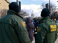 The U.S. Capitol can be seen framed between two U.S. Border Patrol agents as they stand their post supporting the unprecedented security operation in advance of the 59th Presidential Inauguration in Washington, D.C., January 20, 2021.