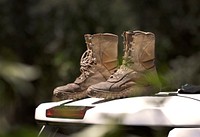 A U.S. Border Patrol agent’s wet boots sit atop a Border Patrol vehicle to dry while he and fellow agents work to clear felled trees two days after Hurricane Ida near Baton Rouge, La., August 31, 2021.