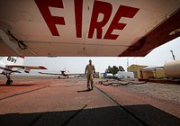 JUL 16 BLM Fire. LAKEVIEW, OR - JULY 16: Single Engine Air Tanker pilot Chuck Gardner walks to his aircraft at the Lakeview Helibase supporting wildland fire suppression efforts on the Bootleg Fire during National Preparedness Level 5 Friday, July 16, 2021, in Lakeview. (Marc Sanchez/BLM). Original public domain image from Flickr