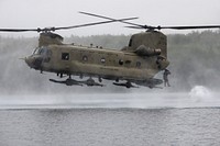 An Army combat engineer from Breacher Company, 6th Brigade Engineer Battalion (Airborne), 4th Infantry Brigade Combat Team (Airborne), 25th Infantry Division, U.S. Army Alaska, jumps from a CH-47 Chinook during helocast training at Clunie Lake, Joint Base Elmendorf-Richardson, Alaska, Aug. 17, 2021.