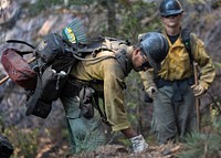 The Feather River Hot Shot performs mop up support to ensure ground is cold during the Dixie Fire in Lassen National Forest, California. USDA Forest Service photo by Cecilio Ricardo. Original public domain image from Flickr