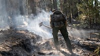 DJ McIlhargie, El Dorado Hot Shot Captain, conducts wet mop duties during the Caldor Fire on the El Dorado National Forest, California.
