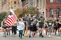 U.S. Customs and Border Protection Acting Commissioner Troy Miller, center left, and Acting Deputy Commissioner Benjamine “Carry” Huffman, center right, lead a group of CBP employees as the participate in the annual Run for the Badge 5K! in Washington, D.C., October 9, 2021.