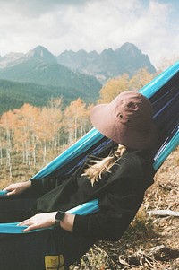 Woman on hammock, mountain view.