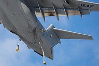 U.S. Army paratroopers assigned to the 2nd Battalion, 377th Parachute Field Artillery Regiment, 2nd Infantry Brigade Combat Team (Airborne), 11th Division, “Arctic Angels,” jump from a U.S. Air Force C-17 Globemaster III assigned to the 62nd Airlift Wing, Joint Base Lewis-McChord, Washington, during airborne operations over Malemute Drop Zone, Alaska, Nov. 10, 2022. Airborne units use Malemute Drop Zone to practice and strengthen airborne skills to preserve air superiority and Arctic operational skills. (Air Force photo by Airman 1st Class Julia Lebens)