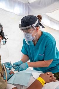 U.S. Navy Sailors assigned to the USNS Comfort perform medical and dental care at medical site in Azua, Dominican Republic during Continuing Promise 2022. 221203-A-MN612-0012AZUA, Dominican Republic (Dec. 3 2022) Canadian Armed Forces Sgt. Cheryl Hopkins, from Barrie, Ontario, assigned to the hospital ship USNS Comfort (T-AH 20), performs a dental filling on a patient at a medical site in Azua, Dominican Republic during Continuing Promise 2022, Dec. 3, 2022. Continuing Promise 2022 is a humanitarian assistance and goodwill mission conducting direct medical care, expeditionary veterinary care, and subject matter expert exchanges with five partner nations in the Caribbean, Central and South America. (U.S. Army photo by Cpl. Genesis Gomez)