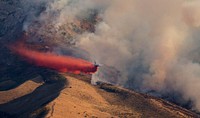 Elko Front 2A large volume air tanker drops a load of red fire retardant near a fireline to provide a fuel break to slow the advance of a wildfire near Elko, Nevada in 2018. Fire hazard on about 81 percent of the Elko Front Landscape is classified as high or very high, threatening watersheds, native plants, wildlife habitats, recreational infrastructure, and private property. Bureau of Land Management photo by Gregory Deimel.