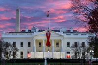 A red ribbon is seen in honor of World AIDS Day, Wednesday, November 30, 2022, on the North Portico of the White House. (Official White House Photo by Adam Schultz)