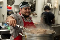 Raphael Bravo, a trainer advocate for cooking, baking and service with Café Reconcile, prepares some food before the restaurant opens in New Orleans, La., Feb. 16, 2023. Café Reconcile runs a volunteer program serving self-initiated youth ages 16-24 who reside in the Greater New Orleans area. Café Reconcile combines hands-on food service training with classroom instruction, individual case management, job placement services, and follow-up support to develop a participant’s ability to become independent, self-sufficient, and successfully employed. Featuring soul-filled local dishes, Café Reconcile is a destination lunch spot for a wide cross-section of New Orleanians as well as visitors from all across the country. Focusing on the kind of “soul food” for which New Orleans is known, the restaurant has earned high praise from local and national critics. The Supplemental Nutrition Assistance Program Employment and Training initiative offers SNAP recipients in Louisiana the opportunity to gain skills, training and work experience. The program is funded by the U.S. Department of Agriculture Food and Nutrition Service, and its goal is to help participants secure regular employment and achieve economic self-sufficiency. (USDA photo by Christophe Paul)  