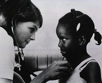 Female Nurse Listens to a Small Patient's Chest During a Medical Examination in the Clinical Center.