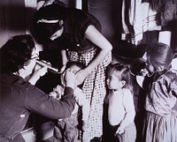 Visiting Nurse Examines Small Children.