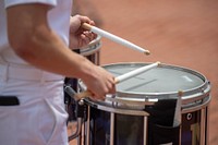 The U.S. Naval Academy Drum and Bugle Corps perform at Radford Terrace during commissioning week.