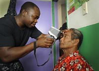 U.S. Navy Petty Officer 2nd Class Fitzroy Hall uses an autorefractor machine during an eye examination at a medical civic assistance program at the Prince Ngu Hospital in Neiafu, Vava'u, Tonga, on April 14, 2011.