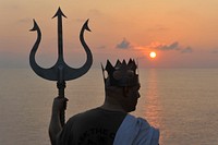 A U.S. Sailor dressed as Poseidon, the Greed god of the sea, aboard aircraft carrier USS Carl Vinson (CVN 70) participates in a Crossing the Line Ceremony, an ancient seafaring tradition to mark the ship's passing of the Equator while under way in the Pacific Ocean May 12, 2011.