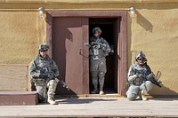 U.S. Soldiers from Blackhorse Company, 2nd Battalion, 3rd Infantry Regiment, 3rd Stryker Brigade Combat Team, 2nd Infantry Division guard a meeting during training at the National Training Center, Fort Irwin, Calif., Aug. 23, 2011.