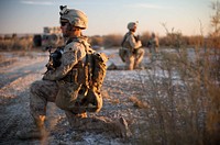 U.S. Marine Corps Sgt. Mitchell Lander, foreground, an enlisted adviser assigned to Border Advisory Team 1, provides security during a movement toward the Afghan border in support of Operation Eagle Hunt in Helmand province, Afghanistan, Dec. 23, 2011.