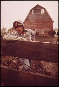 John Dolezal stands in rain on his farm near Bee, Nebraska double the normal rainfall this year compounded the problems of the region's farmers, May 1973. Photographer: O'Rear, Charles. Original public domain image from Flickr