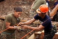 U.S. Marine Corps Lance Cpl. Melinda Carbajal, left, with Marine Wing Support Squadron (MWSS) 172, 1st Marine Aircraft Wing, and Philippine Navy Petty Officer 2nd Class Alfredo Mendoza exchange tools at a construction site at Santa Cruz Elementary School, Palawan province, Philippines, March 22, 2012.