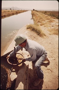 Vincent Humeumptewa, Hopi Indian and employee of the irrigation district, opens canal gates near Parker, May 1972. Photographer: O'Rear, Charles. Original public domain image from Flickr