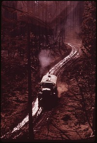 Water truck is used to dampen down thick carpet of soot and ashes, September 1973. Photographer: O'Rear, Charles. Original public domain image from Flickr