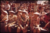 Tourists at a hula dance demonstration. Those who do the dance are rewarded with leis, October 1973. Photographer: O'Rear, Charles. Original public domain image from Flickr