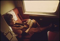 A passenger on the Lone Star passes the time reading in her compartment as the train crosses Oklahoma enroute from Chicago to Houston, Texas, June 1974. Photographer: O'Rear, Charles. Original public domain image from Flickr