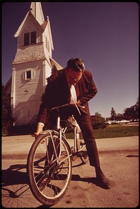 Associate County Court Judge Fred Burns checks tire of bike which he rides daily to the Seward County courthouse, May 1973. Photographer: O'Rear, Charles. Original public domain image from Flickr