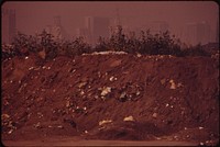 Littered Embankment Near Vine Street Exit Of I-95. Center City Office Buildings In Background, August 1973. Photographer: Swanson, Dick. Original public domain image from Flickr