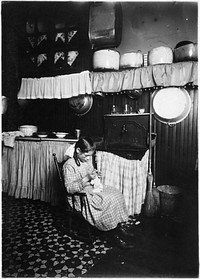 Camela, 12 years old, making Irish lace for collars. Works until 9 P.M. in dirty kitchen, January 1912. Photographer: Hine, Lewis. Original public domain image from Flickr