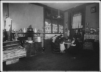 Mrs. Caporale, a widow, picking nuts while her two daughters help her, December 1911. Photographer: Hine, Lewis. Original public domain image from Flickr