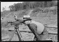 S. P. Graves, instrument man, working on new construction bridge at Norris Dam, October 1933.  Photographer: Hine, Lewis. Original public domain image from Flickr