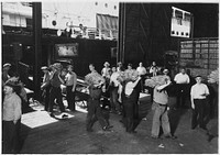 Longshoremen. This shows the prevailing method of transferring bananas from the end on the conveyor that carries them from the hold of the ship onto the dock, July 1937. Photographer: Hine, Lewis. Original public domain image from Flickr