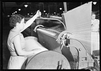 Textiles. Pacific Mills. Barber-Colman High Speed Warper. From front, Operator in act of starting machine, April 1937. Photographer: Hine, Lewis. Original public domain image from Flickr