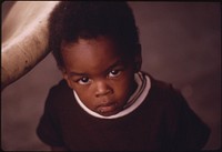 A Black Child On The Rear Porch Of A House In A Very Low Income Area On Chicago's West Side, 06/1973. Photographer: White, John H. Original public domain image from Flickr