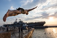 A U.S. Marine with the 26th Marine Expeditionary Unit dives during a swim call near the amphibious assault ship USS Kearsarge (LHD 3) in the Gulf of Aqaba, Jordan, June 22, 2013, upon conclusion of Exercise Eager Lion. Eager Lion is a U.S. Central Command-directed exercise designed to strengthen military-to-military relationships between the U.S. and Jordan.