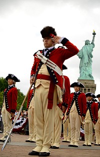 U.S. Army Staff Sgt. James Hague, a drum major with the Old Guard Fife and Drum Corps (FDC), 3rd U.S. Infantry Regiment (The Old Guard), renders a salute following the FDC's performance at Liberty Island in New York, July 4, 2013.
