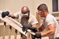 U.S. Air Force Master Sgt. Jonathan Allen, left, and Staff Sgt. Alex Zeman, both with the 131st Civil Engineer Squadron, Missouri Air National Guard, take the back railing off a leased trailer at Whiteman Air Force Base, Mo., June 26, 2013.