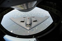 A U.S. Air Force B-2 Spirit bomber aircraft approaches the rear of a KC-135 Stratotanker aircraft before refueling during a training mission over the Midwest, Aug. 1, 2013.